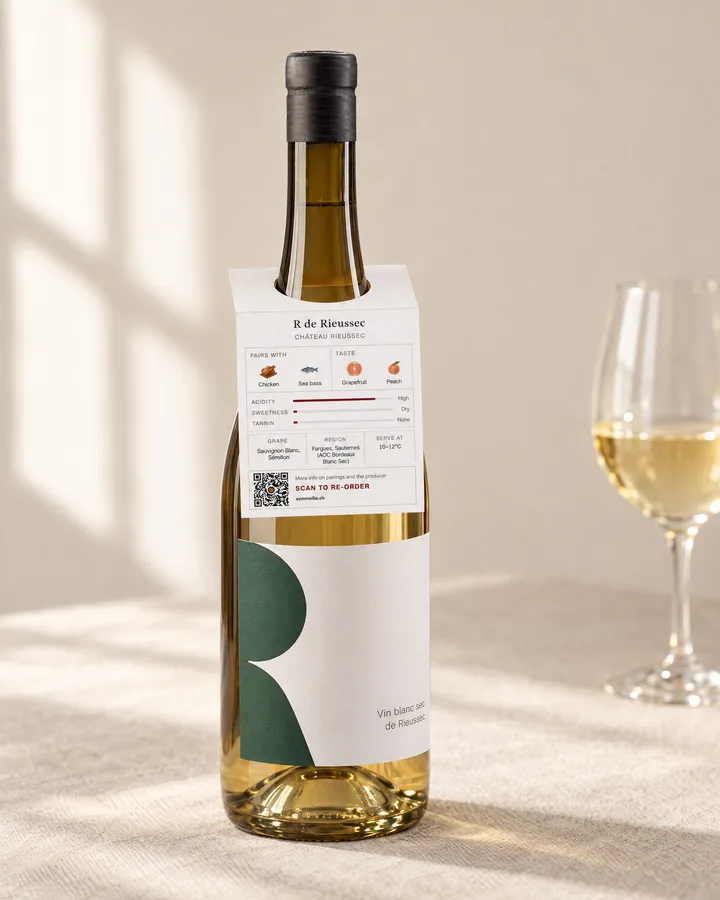 A sommelia. tag hanging on the neck of a wine bottle, showing the food pairings and taste of the wine