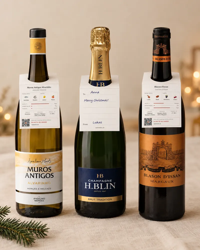 Three bottles — Alvarinho, Champagne and Margaux — each with a sommelia. tag on the neck; the Champagne's tag carries a hand-written note